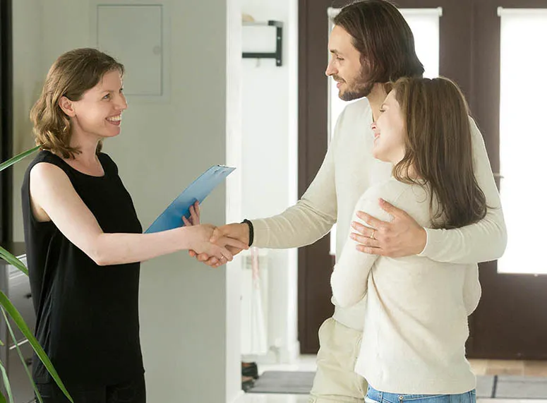 Window covering design consultant greeting homeowners at the door for a free in-home consultation in Phoenix AZ